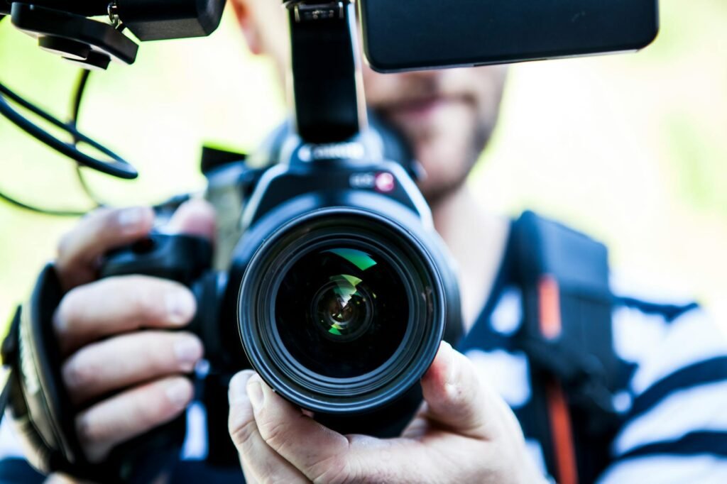 Person Holding Canon Dslr Camera Close-up Photo